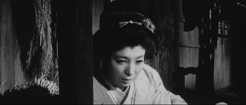 Movie still from “The Sword of Doom” (1966), directed by Kihachi Okamoto – A black - and - white photo of a geisha looking down; Close Up shot, Low angle