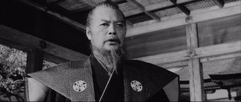 Movie still from “The Sword of Doom” (1966), directed by Kihachi Okamoto – An older man with a long beard wearing a kimono; Close Up shot, Low angle