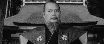 Movie still from “The Sword of Doom” (1966), directed by Kihachi Okamoto – An older man with long hair and a long beard; Close Up shot, Low angle
