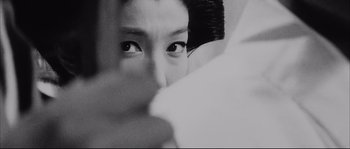 Movie still from “The Sword of Doom” (1966), directed by Kihachi Okamoto – A woman's eyes looking at the camera; Extreme Close Up shot, Over the shoulder angle