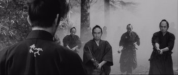 Movie still from “The Sword of Doom” (1966), directed by Kihachi Okamoto – A group of men in traditional japanese garb holding swords; Medium shot, Low angle