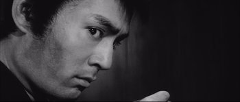 Movie still from “The Sword of Doom” (1966), directed by Kihachi Okamoto – A man's face in a black and white photo; Extreme Close Up shot, Low angle