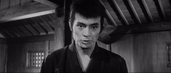 Movie still from “The Sword of Doom” (1966), directed by Kihachi Okamoto – Black and white photograph of a man in a kimono; Close Up shot, Low angle