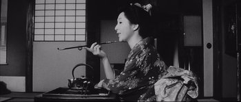 Movie still from “The Sword of Doom” (1966), directed by Kihachi Okamoto – An old photo of a geisha woman brushing her teeth; Close Up shot, Low angle