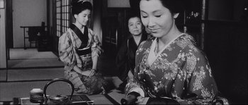 Movie still from “The Sword of Doom” (1966), directed by Kihachi Okamoto – A group of women sitting on the ground; Medium shot, Low angle