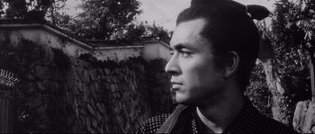 Movie still from “The Sword of Doom” (1966), directed by Kihachi Okamoto – Black and white photograph of a man looking to his left; Close Up shot, Low angle