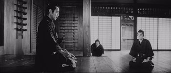 Movie still from “The Sword of Doom” (1966), directed by Kihachi Okamoto – A man and a woman sitting on the floor; Wide shot, Low angle