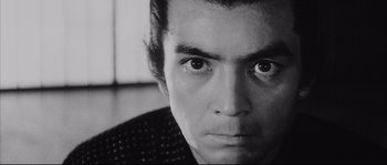 Movie still from “The Sword of Doom” (1966), directed by Kihachi Okamoto – A person's face in a black and white photo; Close Up shot, Low angle