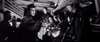 Movie still from “The Sword of Doom” (1966), directed by Kihachi Okamoto – A group of people sitting in a room together; Medium shot, Low angle
