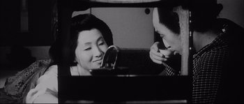 Movie still from “The Sword of Doom” (1966), directed by Kihachi Okamoto – A man and a woman are looking at a laptop; Close Up shot, Over the shoulder angle