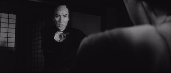 Movie still from “The Sword of Doom” (1966), directed by Kihachi Okamoto – A black and white photo of a man in a mirror; Close Up shot, Low angle
