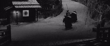 Movie still from “The Sword of Doom” (1966), directed by Kihachi Okamoto – A group of people walking down a snow covered street; Extreme Wide shot, High angle