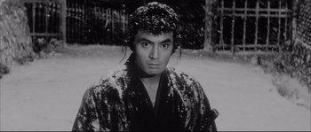 Movie still from “The Sword of Doom” (1966), directed by Kihachi Okamoto – A black and white photo of a man in a kimono; Close Up shot, Low angle