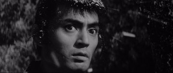 Movie still from “The Sword of Doom” (1966), directed by Kihachi Okamoto – A black - and - white photo of a man's face; Close Up shot, Low angle