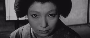 Movie still from “The Sword of Doom” (1966), directed by Kihachi Okamoto – A black - and - white photo of a woman's face; Close Up shot, High angle