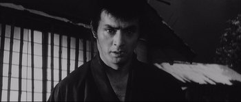 Movie still from “The Sword of Doom” (1966), directed by Kihachi Okamoto – Black and white photograph of a man in a kimono; Close Up shot, Low angle