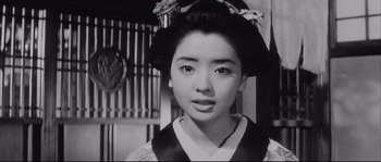 Movie still from “The Sword of Doom” (1966), directed by Kihachi Okamoto – An old photo of an asian woman in traditional dress; Close Up shot, Low angle