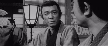Movie still from “The Sword of Doom” (1966), directed by Kihachi Okamoto – An old photo of a man wearing a kimono; Close Up shot, Low angle