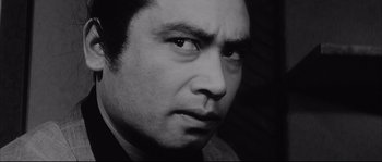 Movie still from “The Sword of Doom” (1966), directed by Kihachi Okamoto – Black and white photograph of a man's face; Close Up shot, Low angle