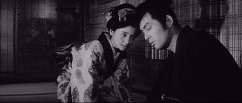 Movie still from “The Sword of Doom” (1966), directed by Kihachi Okamoto – A man and a woman in traditional japanese clothing; Close Up shot, Low angle