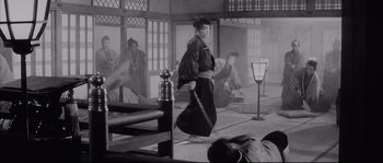 Movie still from “The Sword of Doom” (1966), directed by Kihachi Okamoto – An old photo of a woman walking in a room; Wide shot, High angle