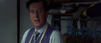 Movie still from “The Tailor of Panama” (2001), directed by John Boorman – A person wearing a tie and a vest; Close Up shot, Low angle