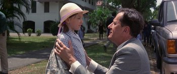 Movie still from “The Tailor of Panama” (2001), directed by John Boorman – A man and a little girl with a backpack; Medium shot, Over the shoulder angle