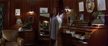 Movie still from “The Tailor of Panama” (2001), directed by John Boorman – A room filled with furniture and a mirror; Wide shot, Overhead angle