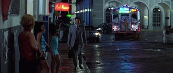 Movie still from “The Tailor of Panama” (2001), directed by John Boorman – A man walking down a street at night; Wide shot, Low angle