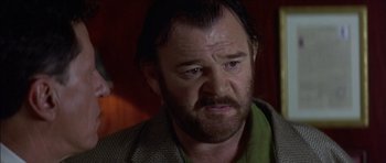 Movie still from “The Tailor of Panama” (2001), directed by John Boorman – A person wearing a green shirt; Close Up shot, Low angle