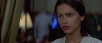 Movie still from “The Tailor of Panama” (2001), directed by John Boorman – A person with a serious look on their face; Close Up shot, Over the shoulder angle