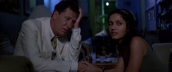 Movie still from “The Tailor of Panama” (2001), directed by John Boorman – A man and a woman sitting at a dinner table; Close Up shot, Over the shoulder angle