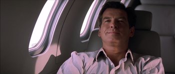 Movie still from “The Tailor of Panama” (2001), directed by John Boorman – A person sitting in a plane window; Close Up shot, Low angle