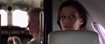 Movie still from “The Tailor of Panama” (2001), directed by John Boorman – A woman sitting in a car looking into a mirror; Close Up shot, Low angle
