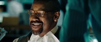 Movie still from “The Taking of Pelham 123” (2009), directed by Tony Scott – A person wearing glasses and a beard; Close Up shot, Low angle