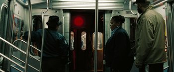 Movie still from “The Taking of Pelham 123” (2009), directed by Tony Scott – Two people standing in front of a subway train; Medium shot, High angle