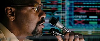 Movie still from “The Taking of Pelham 123” (2009), directed by Tony Scott – A person holding a microphone; Close Up shot, Low angle