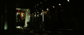 Movie still from “The Taking of Pelham 123” (2009), directed by Tony Scott – A train is parked in the dark at night; Extreme Wide shot, High angle