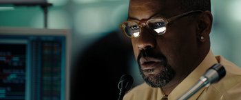 Movie still from “The Taking of Pelham 123” (2009), directed by Tony Scott – A person with a microphone; Close Up shot, Over the shoulder angle