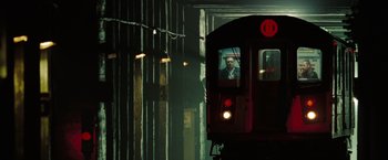 Movie still from “The Taking of Pelham 123” (2009), directed by Tony Scott – A train is traveling down the tracks at night; Wide shot, Low angle