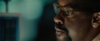 Movie still from “The Taking of Pelham 123” (2009), directed by Tony Scott – A person wearing glasses; Extreme Close Up shot, Over the shoulder angle