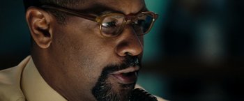 Movie still from “The Taking of Pelham 123” (2009), directed by Tony Scott – A person wearing glasses; Extreme Close Up shot, Over the shoulder angle