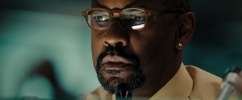 Movie still from “The Taking of Pelham 123” (2009), directed by Tony Scott – A person wearing glasses and a beard; Close Up shot, Low angle