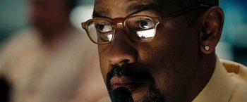 Movie still from “The Taking of Pelham 123” (2009), directed by Tony Scott – A person wearing glasses; Extreme Close Up shot, Over the shoulder angle