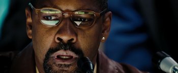 Movie still from “The Taking of Pelham 123” (2009), directed by Tony Scott – A person with a microphone; Extreme Close Up shot, Low angle