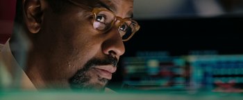 Movie still from “The Taking of Pelham 123” (2009), directed by Tony Scott – A person wearing glasses looking at a computer screen; Extreme Close Up shot, Low angle