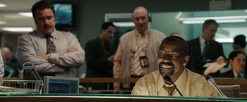 Movie still from “The Taking of Pelham 123” (2009), directed by Tony Scott – A group of men standing in a room; Medium shot, Over the shoulder angle