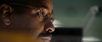 Movie still from “The Taking of Pelham 123” (2009), directed by Tony Scott – A person wearing glasses; Extreme Close Up shot, Low angle