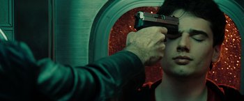 Movie still from “The Taking of Pelham 123” (2009), directed by Tony Scott – A man holding a gun up to his face; Close Up shot, Over the shoulder angle