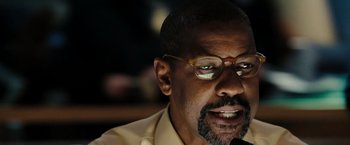 Movie still from “The Taking of Pelham 123” (2009), directed by Tony Scott – A person wearing glasses; Close Up shot, Low angle